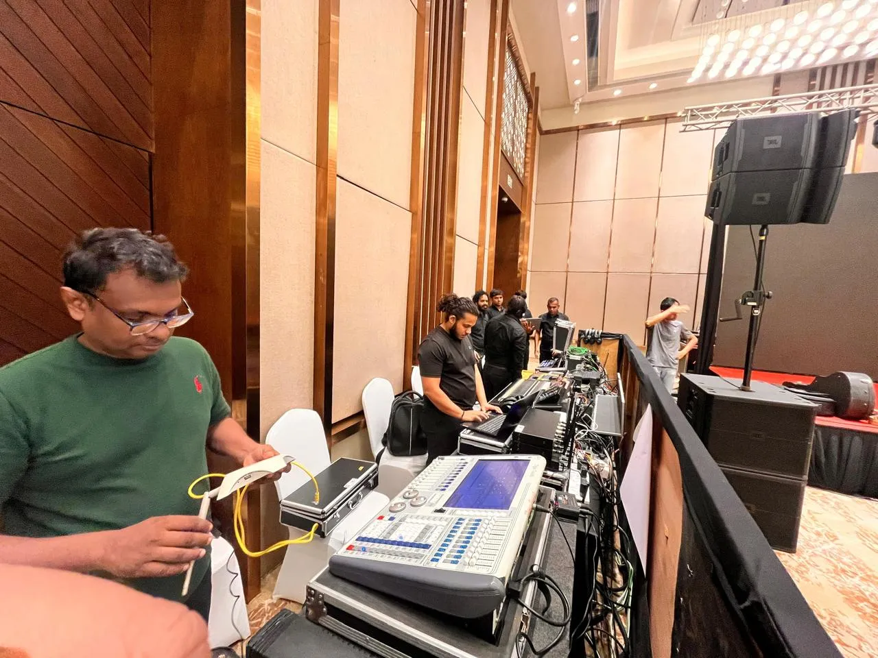 Sound engineer operating an audio mixer with keyboard and display