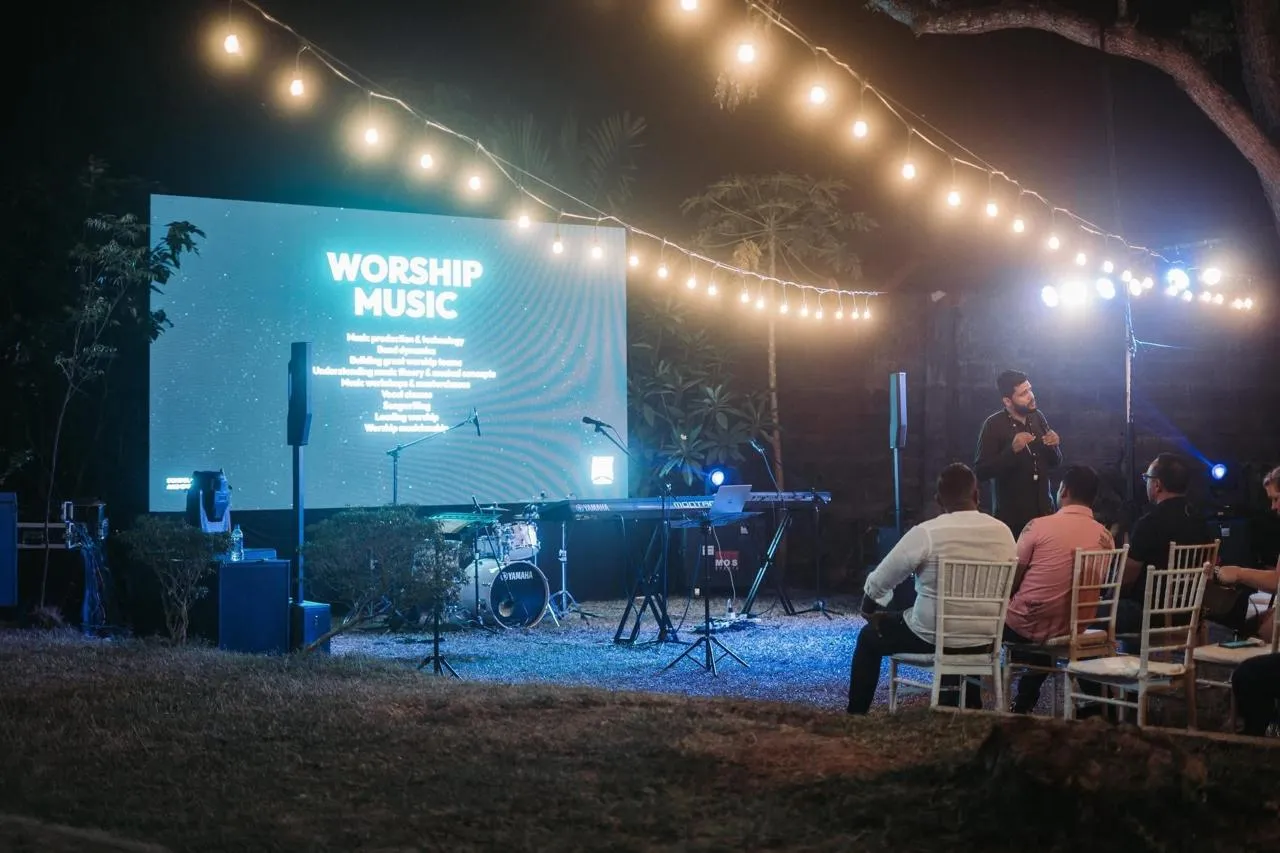 Outdoor worship event with stage sound, lighting and audience
