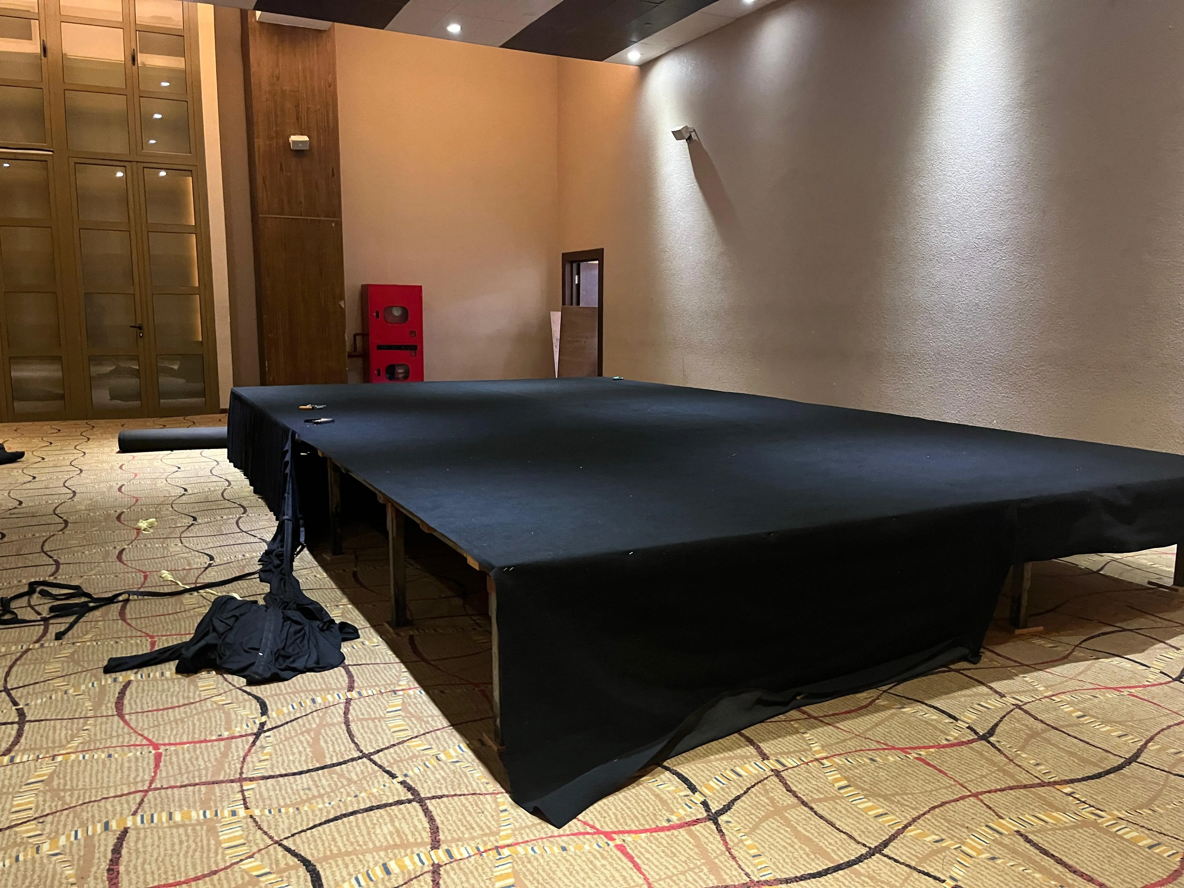 Audience seated at a conference event with an LED screen