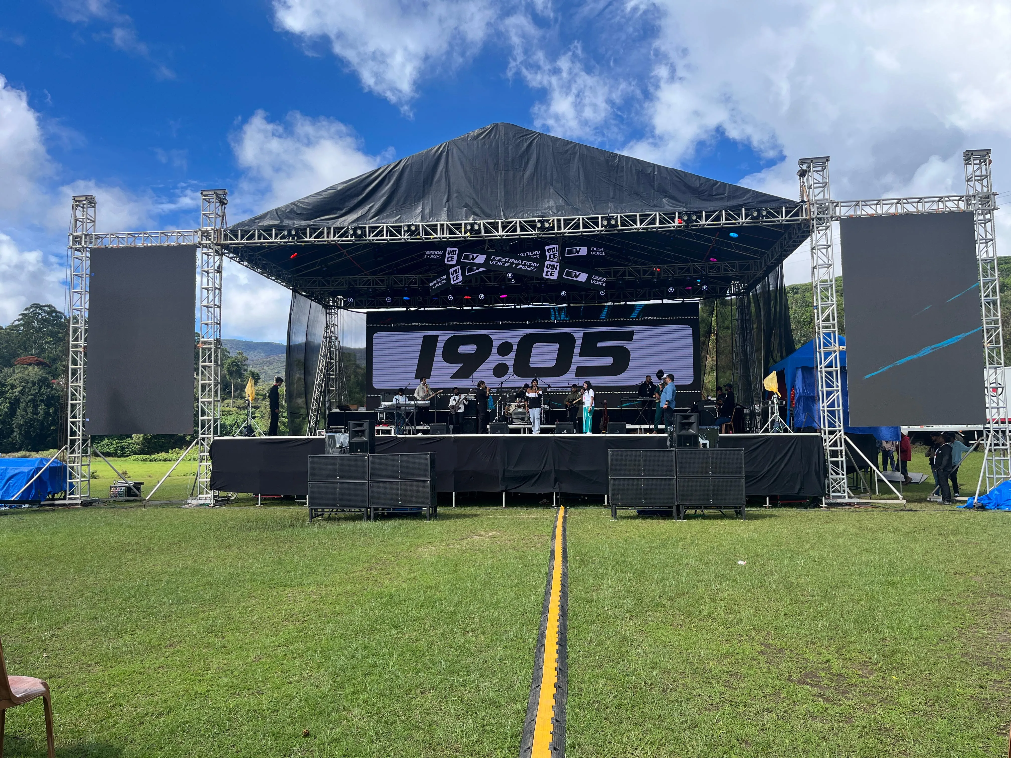 Outdoor festival stage with truss towers, LED screens and line-array speakers