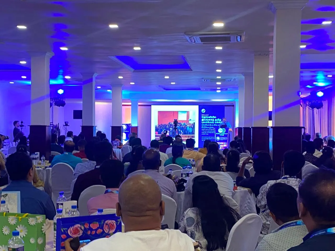 Large LED video wall with blue and neon graphics at an event