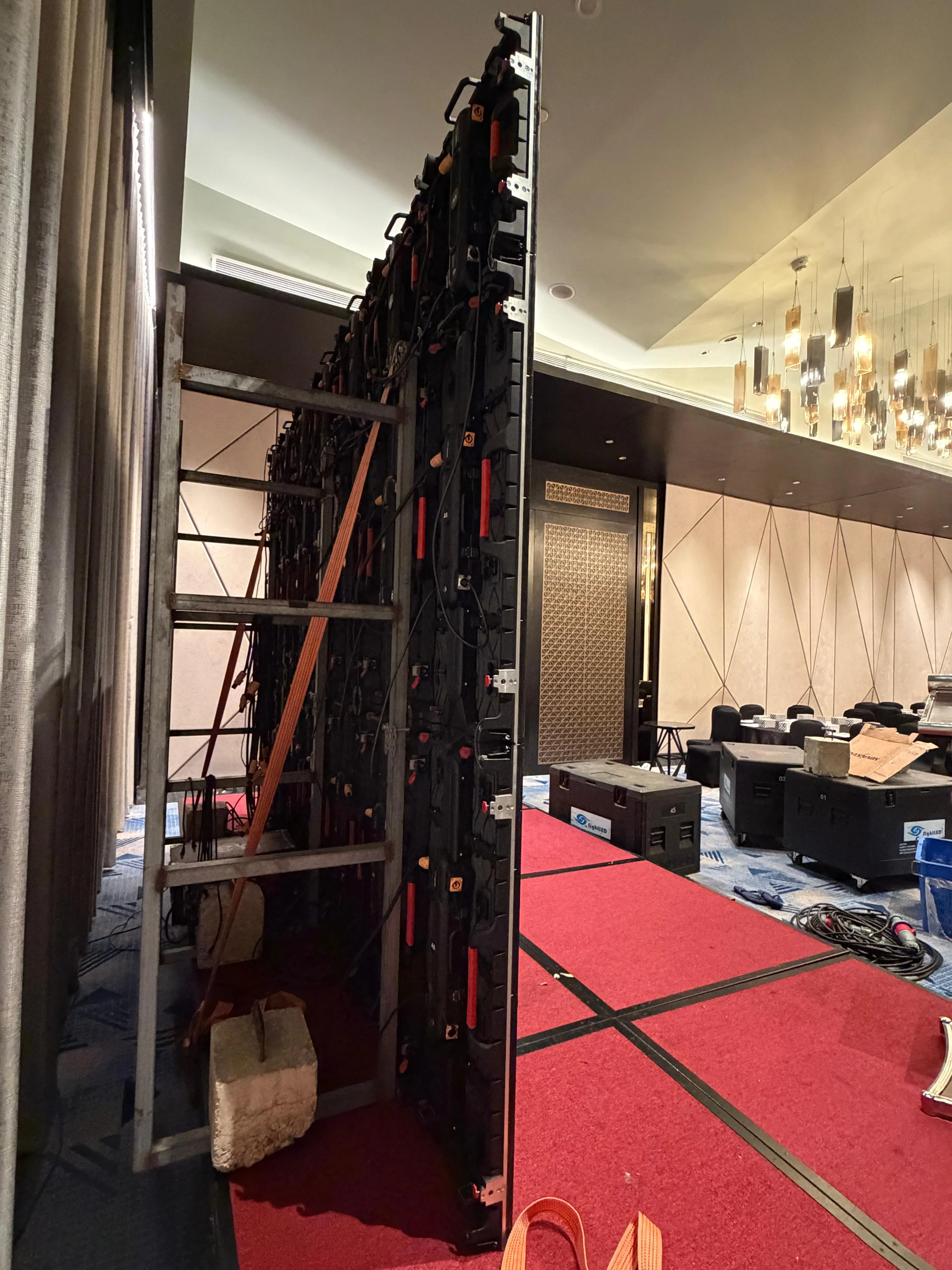 Stage lighting rig with multiple coloured spotlights overhead