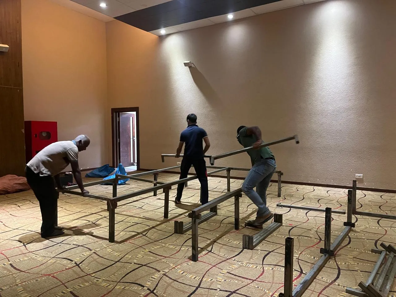 Crew assembling stage barriers and platform framework